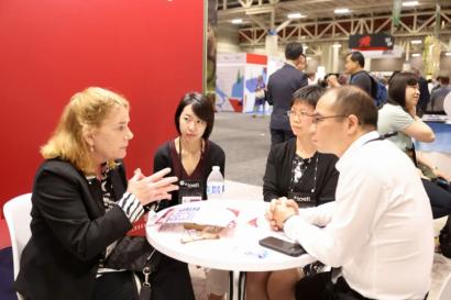 Women and men around a table discussing interational education at NAFSA 