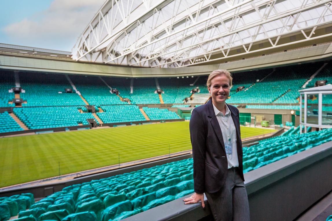 a student intern standing in an empty sports arena