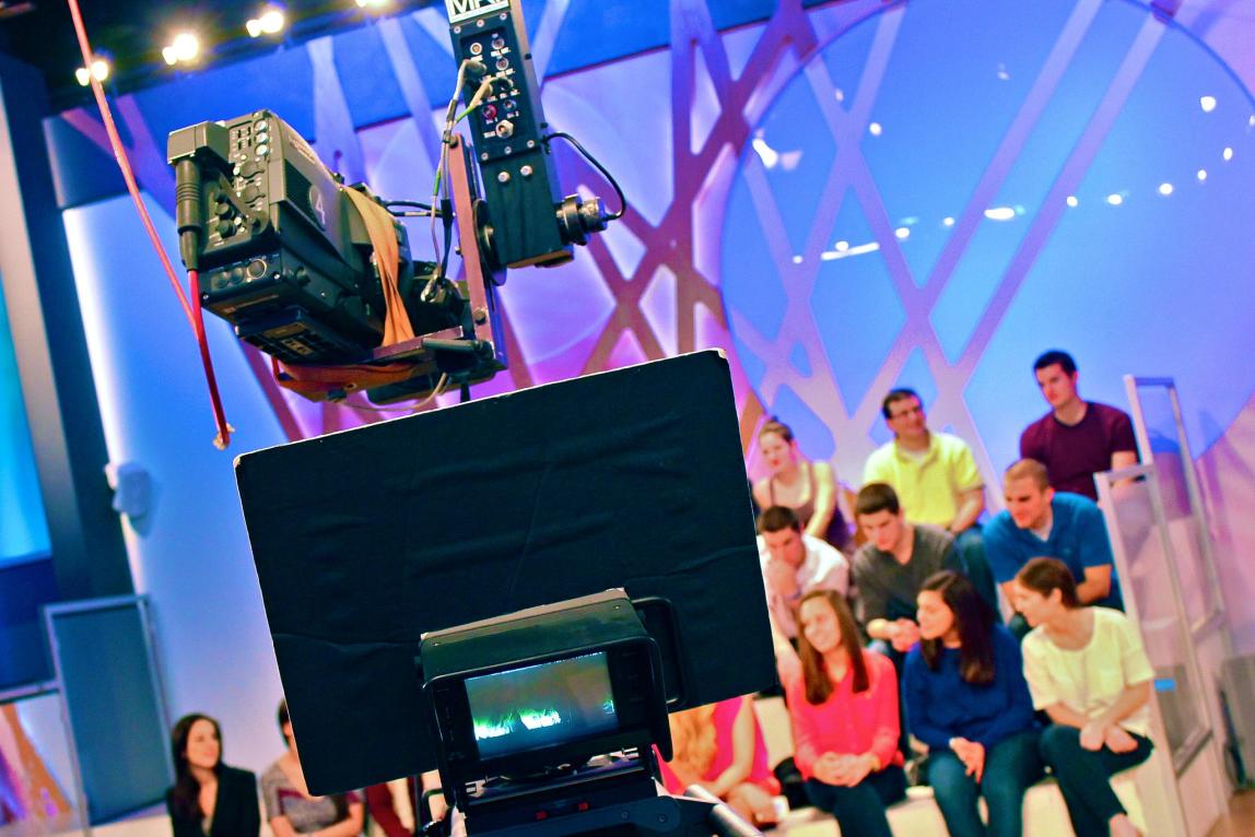 a studio audience behind a camera in Milan