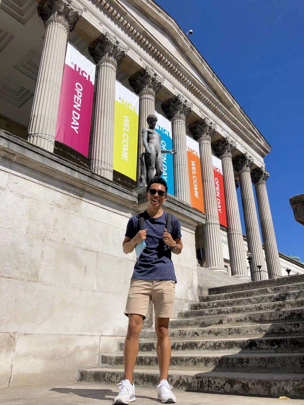 a student standing on the steps of University College London