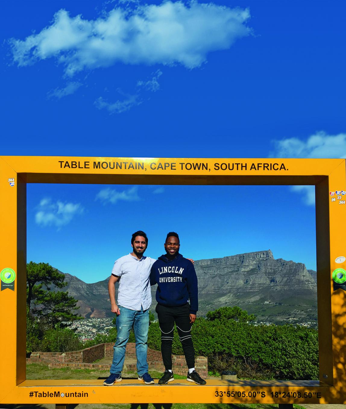 Two Internship students standing in front of Table Mountain in Cape Town