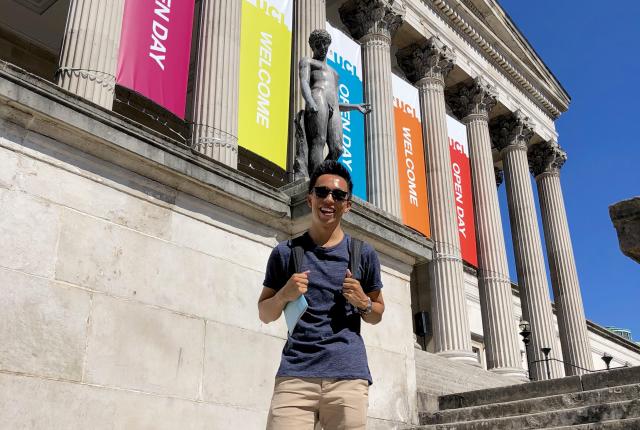 a student standing on the steps of University College London