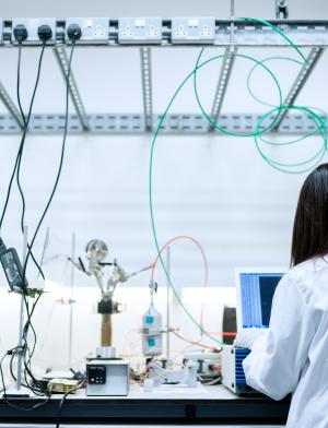 Female engineer in the lab with her back to the camera