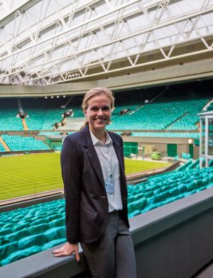 a student intern standing in an empty sports arena