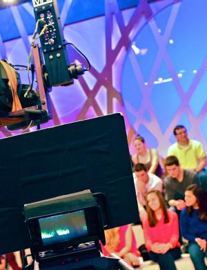 a studio audience behind a camera in Milan